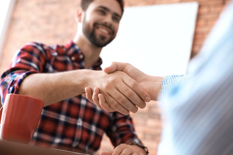 roofing contractor shaking hands with client after interview roofing contractor shaking hands with client after interview