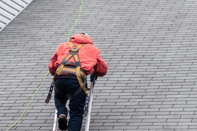 roof inspection expert climbing up latter to roof top roof inspection expert climbing up latter to roof top